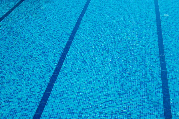 Sfondo della piscina piastrellata blu con acqua increspata fresca e limpida