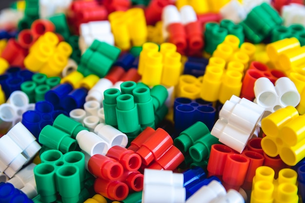 Sfondo di blocchi di plastica colorati dettagli Parti di piccoli pezzi di ricambio luminosi per giocattoli