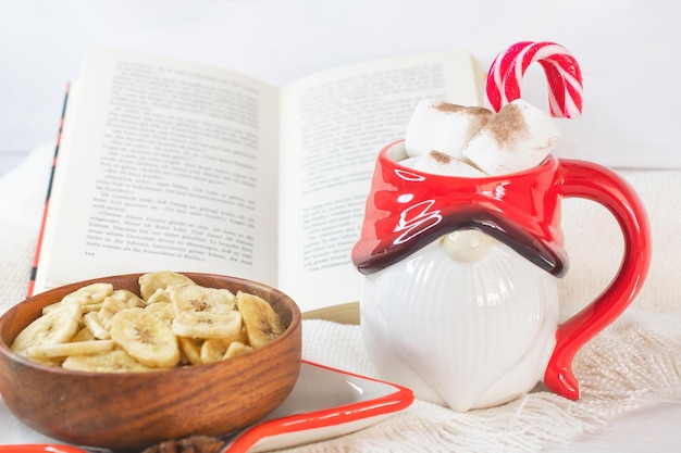 Sfondo di Capodanno Tazza di Babbo Natale con marshmallow Biscotti di Natale libro aperto