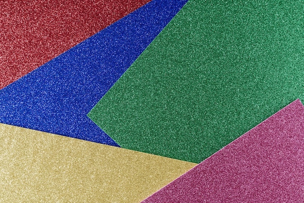 Sfondo di carta texturata blu giallo verde e rosso in colori vivaci motivo geometrico