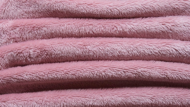 Sfondo di coperta di cotone rosa peloso piegato con consistenza calda e morbida