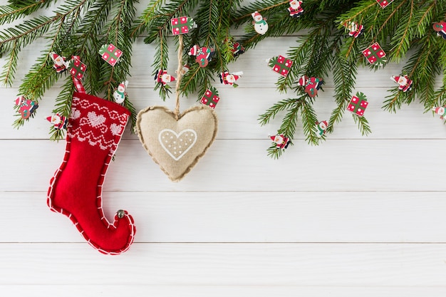 Sfondo di natale. Albero di abete di natale con la decorazione sul fondo bianco del bordo di legno con lo spazio della copia.