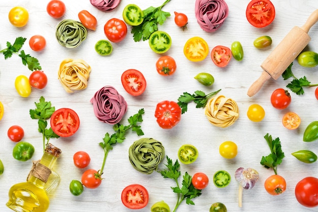 Sfondo di pasta tagliatelle di pasta secca e ingredienti su sfondo bianco Vista dall'alto Spazio libero per il testo