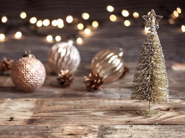 Sfondo festivo di Natale o Capodanno, giocattoli vintage sull'albero di Natale su uno sfondo di legno con una ghirlanda con luci