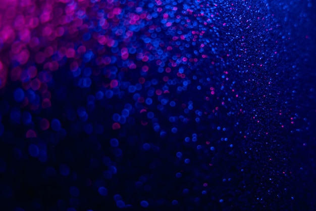 Sfondo fluorescente Luce bokeh Sfocatura brilla riflesso Blu neon sfocato rosa magenta bagliore glitter texture su sovrapposizione astratta nero scuro