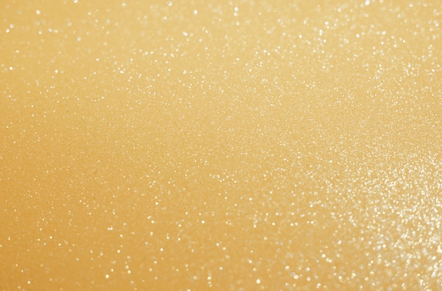 Sfondo glitter oro sfocato per la progettazione di cartoline di Natale