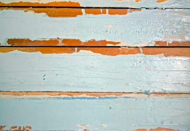Sfondo in legno con vernice blu scrostata Foto di sfondo di assi di legno con vernice scrostata Sotto la vernice blu si può vedere il legno fresco delle tavole