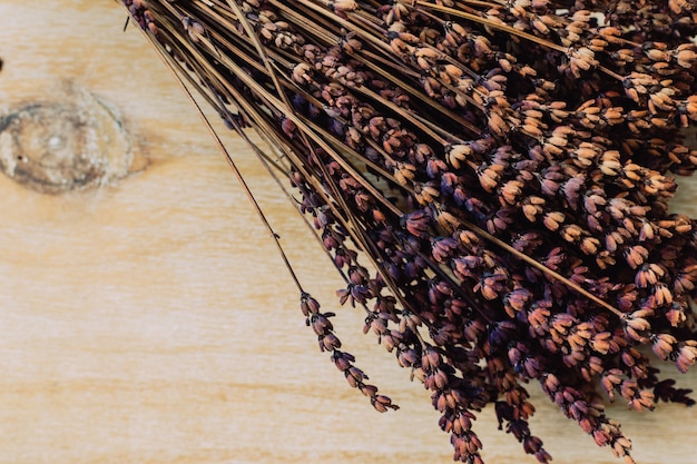 sfondo vintage con un banch di lavanda all&#39;angolo su un tavolo di legno naturale.