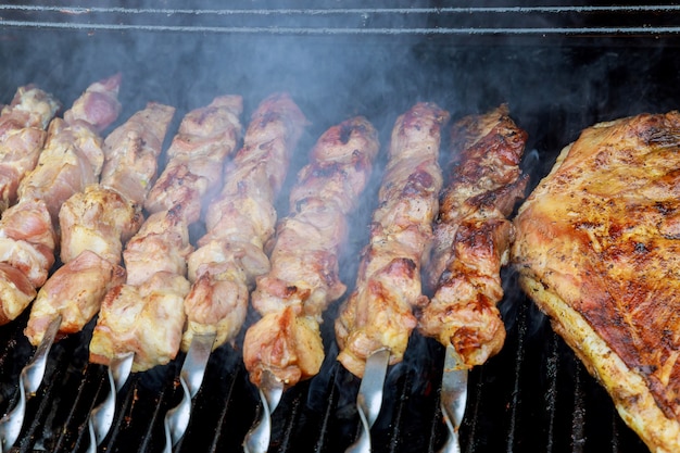 Shashlik marinato che prepara su una griglia del barbecue sopra carbone di legna. Shashlik o Shish kebab