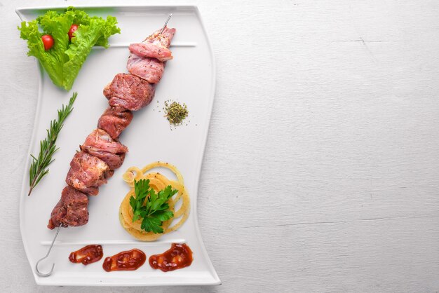 Shish kebab crudo su sfondo di legno Vista dall'alto Spazio libero per il testo