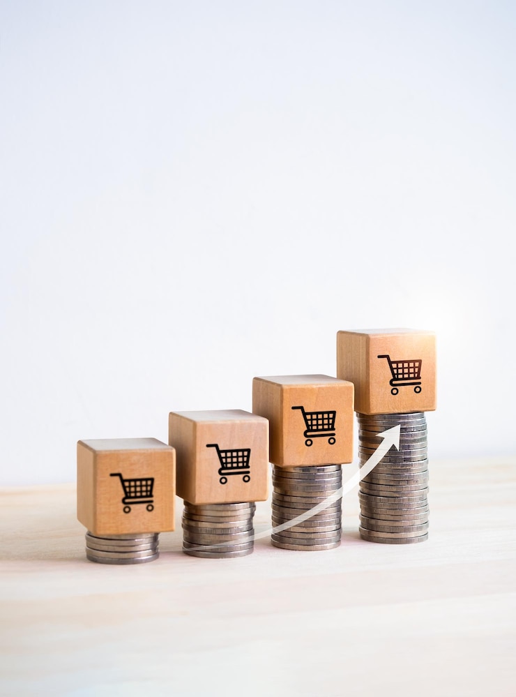Photo shopping cart icon on wood cube blocks on coin stacks as a growth graph steps with rise arrow on white background with copy space vertical business growth sales increase and profit income concepts