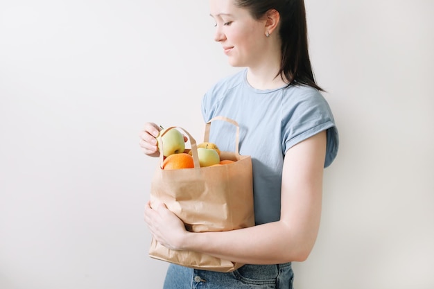 shopping mangiare sano e concetto ecologico primo piano della donna che tiene una borsa ecologica con frutta