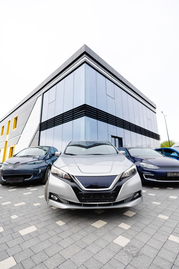Side view of electric cars hood standing beside new cars for sell outdoors Choosing and buying new car concept