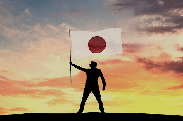 Silhouette maschile che sventola la bandiera del Giappone 3D Rendering