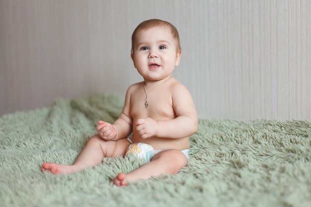 Simpatico adorabile neonato di 3 falene con pannolini. Hapy piccola bambina o ragazzo guardando la telecamera. Corpo e pelle asciutti e sani per il concetto di bambini. Asilo nido