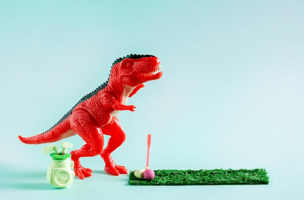 Simpatico dinosauro giocattolo rosso che gioca a mini golf su sfondo blu