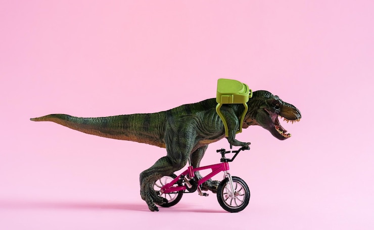 Foto simpatico giocattolo di dinosauro felice che guida la bicicletta con zaino su sfondo rosa pastello simpatico biglietto da visita ecologico per il trasporto