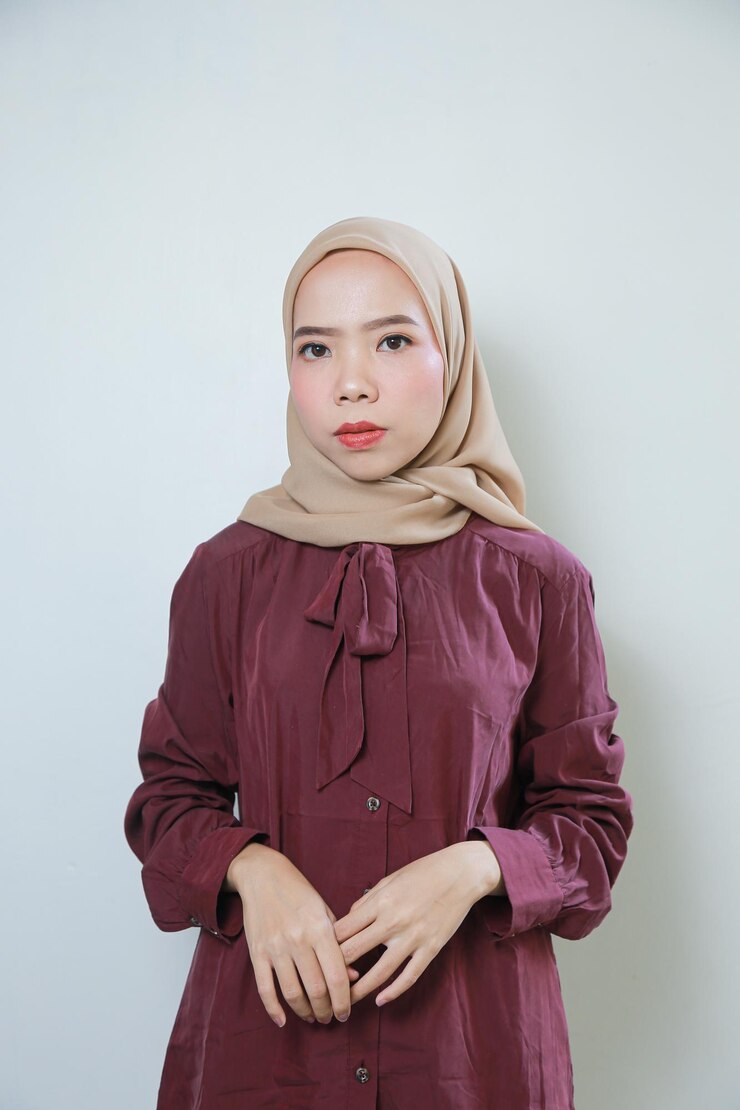 Photo smiling young asian muslim woman feels confident and joyful isolated over white background