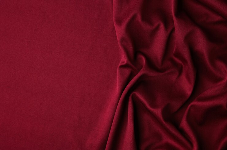 Smooth elegant burgundy silk or satin luxury cloth texture background.