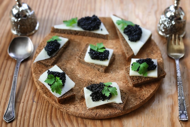 Snack caviale nero su uno sfondo marrone di legno