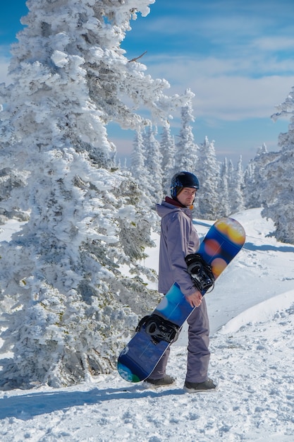 Snowboarder in casco sulla cima delle montagne