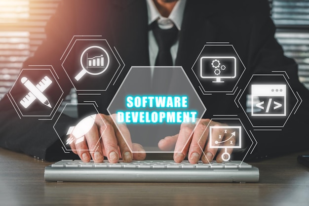 software development concept businessman typing on keyboard with software development icon on virtual screen