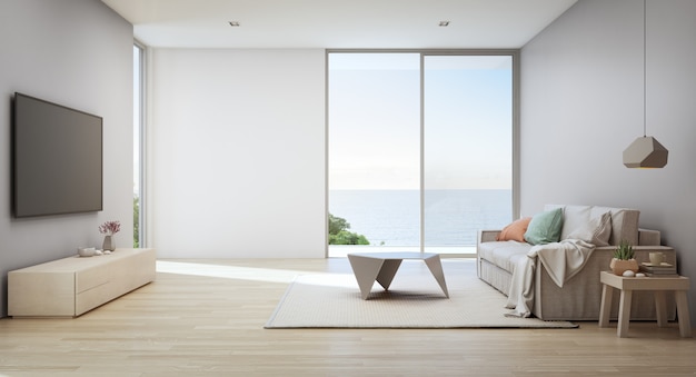 Soggiorno vista mare di casa sulla spiaggia di lusso con porta in vetro e terrazza in legno.