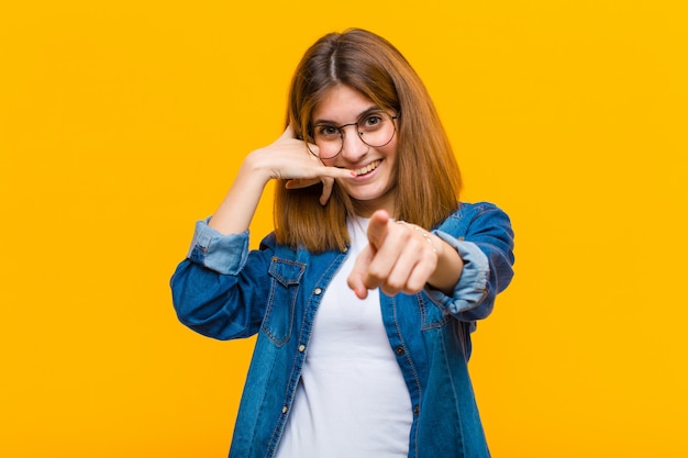 sorridendo allegramente e indicando la parte anteriore mentre fai una telefonata in seguito gesticolano, parlando al telefono