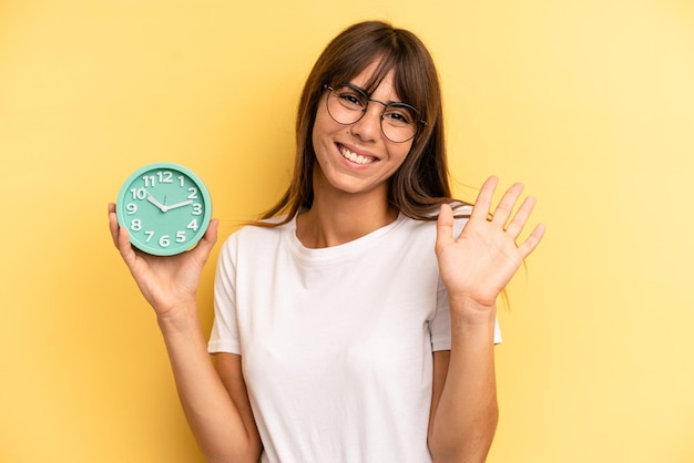 Sorridendo felicemente agitando la mano accogliendoti e salutandoti