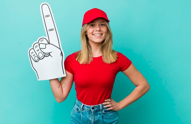 sorridendo felicemente con una mano sul fianco e fiducioso