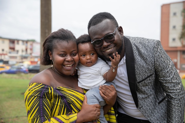 Sorridente famiglia africana bambino di sei mesi in mezzo a madre e padre