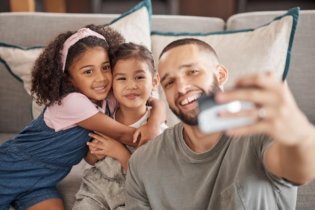 Sorriso felice e selfie di famiglia di padre e figli si rilassano sul divano del soggiorno mentre si legano divertendosi e godendosi del tempo di qualità insieme Ama la pace e la felicità per papà e bambini dal Brasile