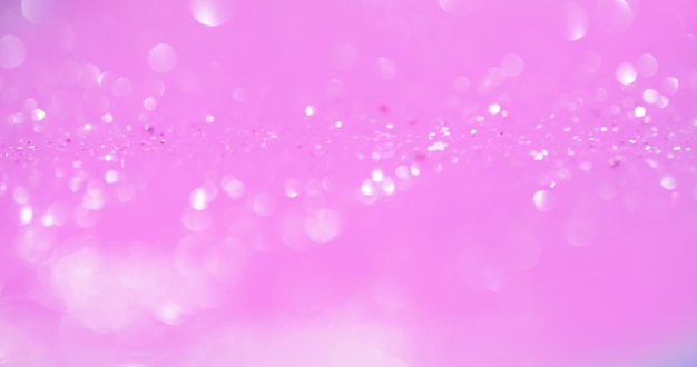 Sovrapposizione di luce bokeh Sfocatura bagliore Riflessione di paillettes Cerchi bianchi sfocati sfocati bagliore su sfondo astratto glamour di colore rosa pastello