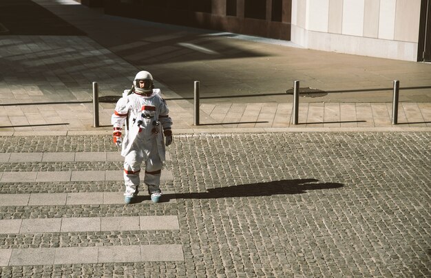 Spaceman in una stazione futuristica. astronauta con tuta spaziale che cammina in un'area urbana