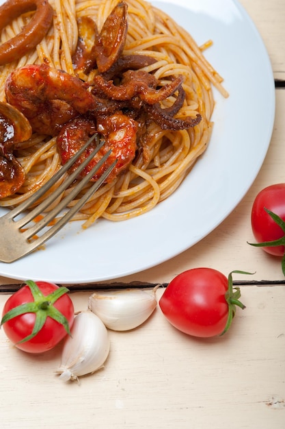 Spaghetti ai frutti di mare italiani su salsa di pomodoro rosso