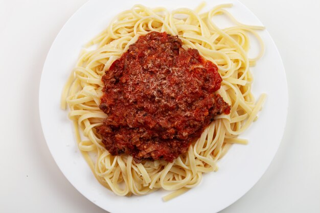 Spaghetti della pasta con la salsa di ragu sul piatto bianco