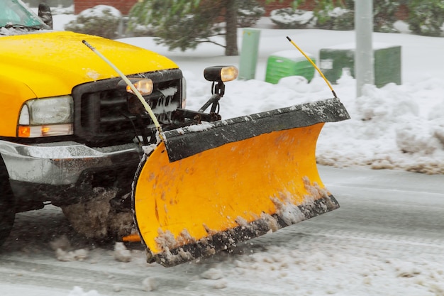 Spazzaneve che pulisce la neve dalla strada di città