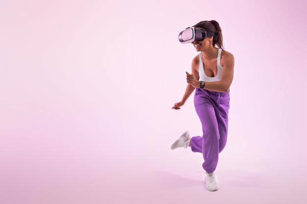 Sperimentare il gioco della donna afroamericana metaverse con occhiali per realtà virtuale spazio libero su sfondo rosa