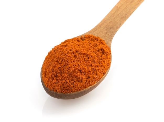 Spezie paprika in cucchiaio isolato su sfondo bianco