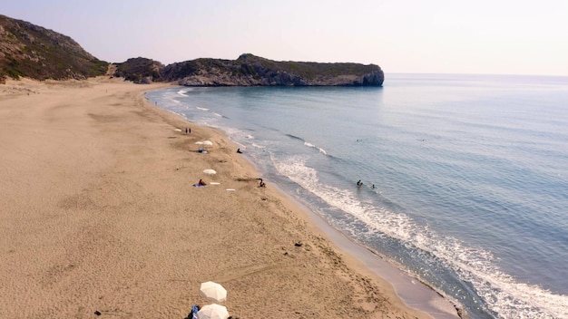 Spiaggia sabbiosa vicino all'oceano e montagne sul paesaggio naturale dell'isola