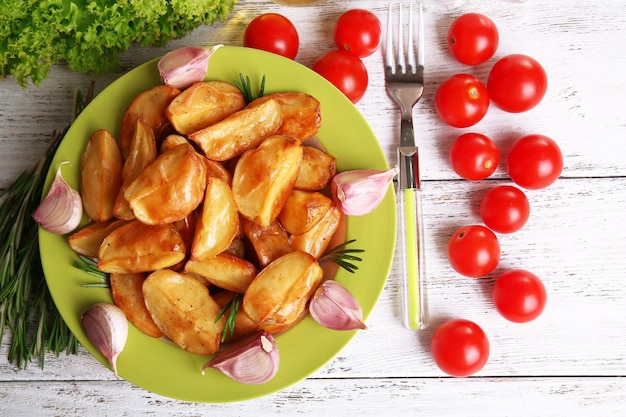 Spicchi di patate al forno sul primo piano della tavola di legno