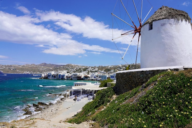 Splendida vista del villaggio di Mykonos con il tradizionale mulino a vento e l'isola di Mykonos in Grecia