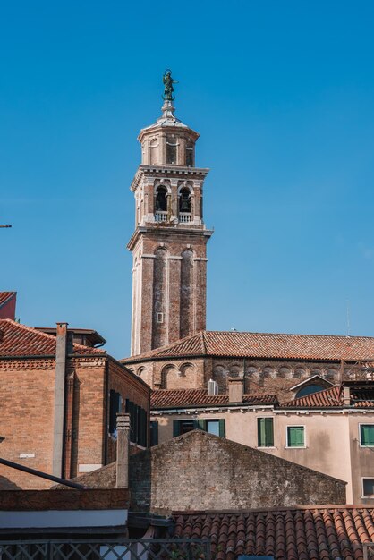 Splendida vista diurna di Venezia con la torre dell'orologio e le barche dal tetto