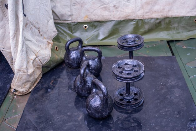 Sport nella palestra dell'esercito di soldati russi su navi da guerra pesanti proiettili kettlebell e bilanciere...