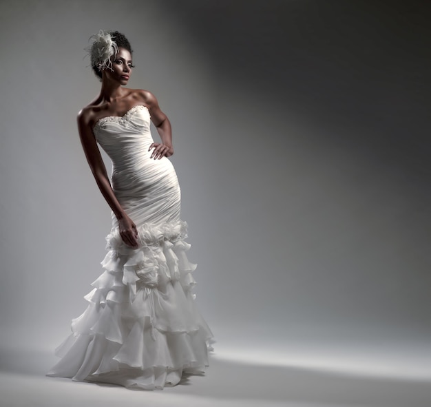 Sposa afro-americana in un vestito su sfondo bianco