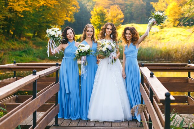 Sposa con le damigelle nel parco il giorno del matrimonio