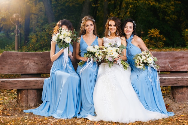 Sposa con le damigelle nel parco il giorno del matrimonio