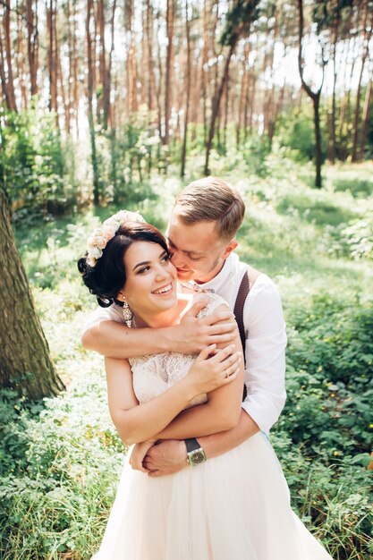 Sposa e sposo che abbracciano il giorno del matrimonio, giovani coppie felici che baciano nel parco in natura, San Valentino