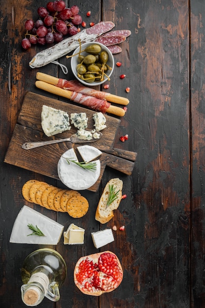 Spuntini spagnoli, formaggio a base di carne, set di erbe aromatiche, sul tavolo di legno scuro, piatto laici