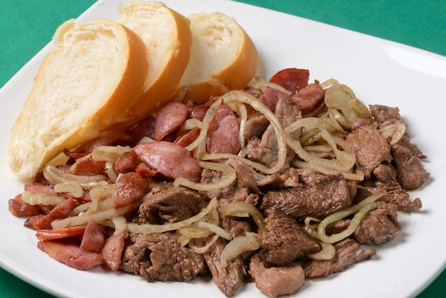 Spuntino di carne arrosto e peperoni con cipolla accompagnato da fette di pane. gastronomia brasiliana.